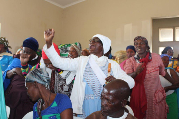 Above: Elderly Mita Mnyandu (in white) in excitement when MEC Pillay reported on a R62 million housing project for eQhudeni village