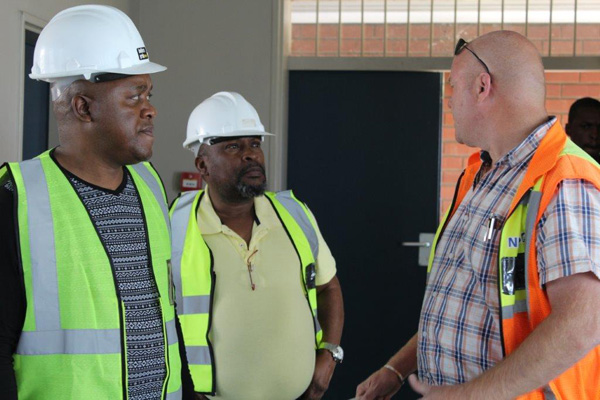 The project Manager Mr Gert Hendrikser taking the Head of Department Mr Mdadane and Mr Gcina Hadebe on a site tour while Mr Phakamani Mbhele, a site foreman looks on.