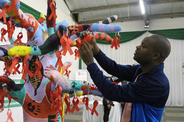 Mr Vusi Masinga, Public Works’ Employee Health Wellness Practitioner, hanging his message of hope and